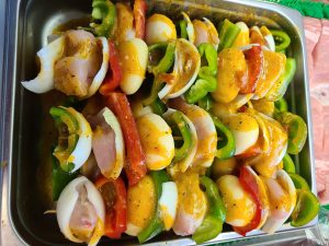 prepared kabobs for grills with mixed vegetables and drenched in sauce